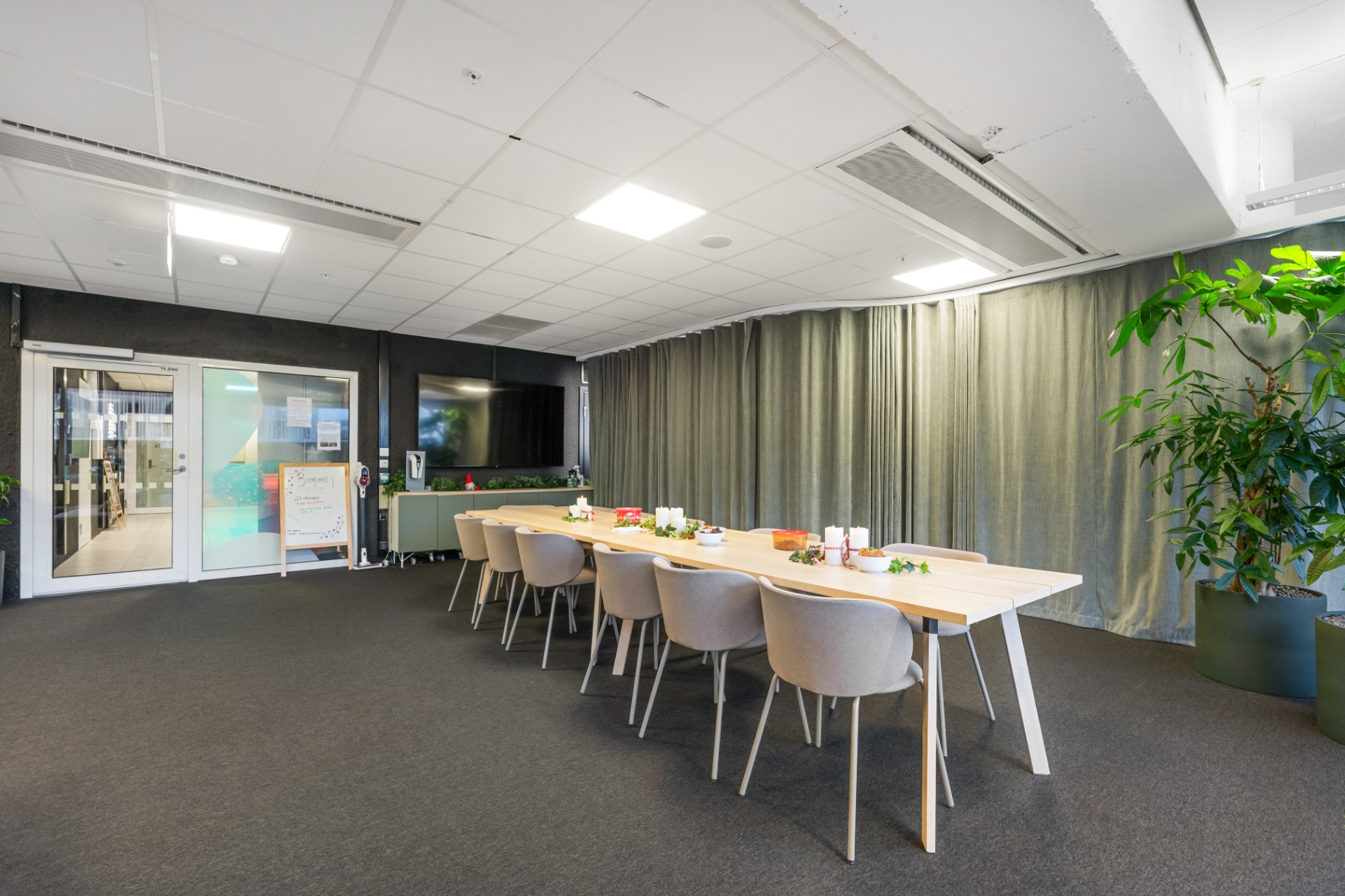The HUB Social Area set for a gathering with a long dining table and soft lighting.